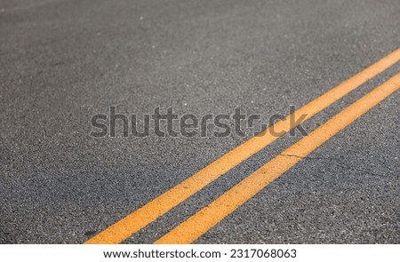 Double yellow line streets symbolize traffic regulation, no passing zones, road boundaries, safety, and maintaining order