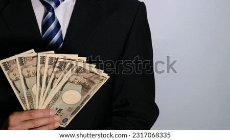 Businessman with big money.
Translation: Bank of Japan, 10000, Bank of Japan, National Printing Bureau, Yukichi Fukuzawa.