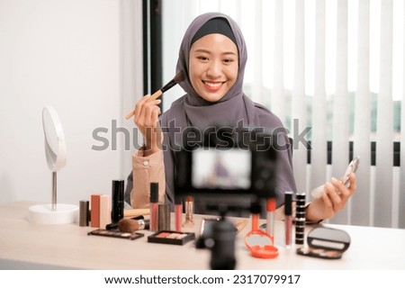 Beauty blogger beautiful girl doing makeup live and showcasing cosmetics, captivating her audience with expert application techniques and sharing valuable tips and tricks for achieving flawless looks.