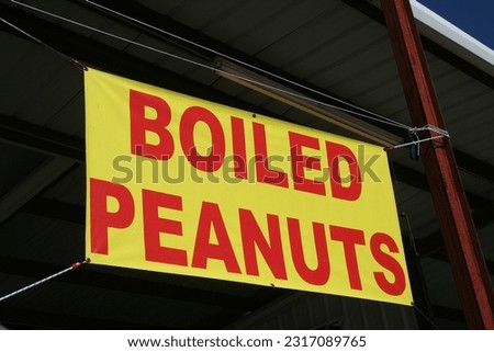 Red and Yellow Sign Advertising Boiled Peanuts 