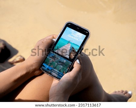 Photo edit with mobile smart phone concept. Seascape view photography editing on app on smartphone screen in woman's hands, travel at the beach in summer. Retouching images to post on social networks.