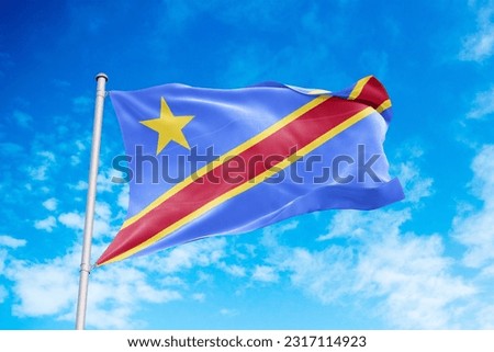 Congo Democratic flag waving in the wind, blue sky background