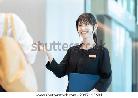 Hotel staff showing guests around Royalty-Free Stock Photo #2317115681