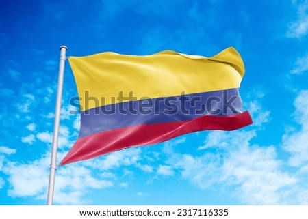 Colombia flag waving in the wind, blue sky background