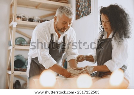 Adult senior couple at artwork in pottery Royalty-Free Stock Photo #2317152503