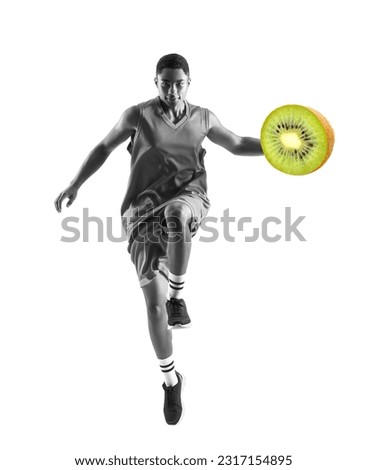 Jumping African-American basketball player with juicy kiwi on white background