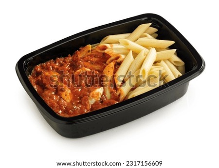 Penne pasta with a creamy tomato sauce in a black plastic box on a white background, isolated with clipping path Royalty-Free Stock Photo #2317156609
