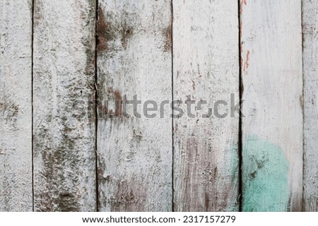 White and green wooden background with a grunge texture. The weathered appearance adds character. Abstract elements enhance the overall design. Out of focus.