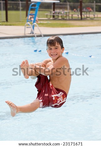 Little Boy Having Fun Jumping in the Pool