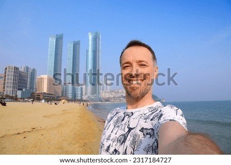 Foreign tourist selfie at Haeundae beach in Busan, South Korea.