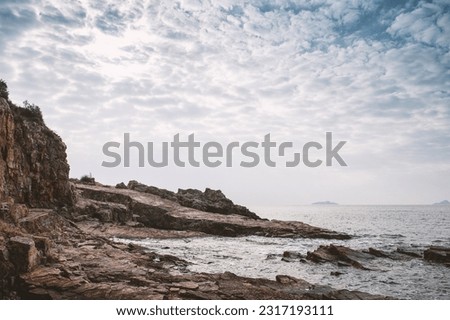 Nature background with cliff of rock, sea and dramatic sky