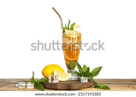 Glass of ice tea with lemon and mint on wooden table against white background