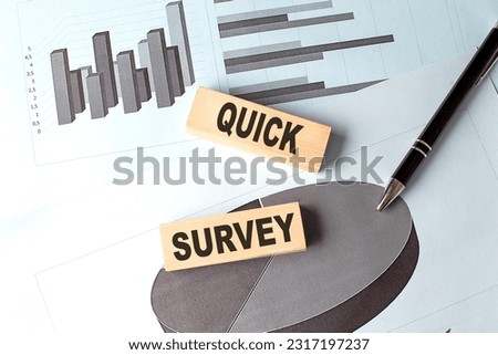 QUICK SURVEY text on a wooden block on chart background