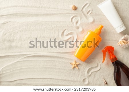 Sunburn prevention concept. Above view photo of SPF inscription, tube,spray and bottle of sunscreen, shells and starfish on the sand on isolated background with copyspace Royalty-Free Stock Photo #2317203985