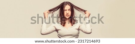 Frustrated woman having a bad hair. Woman having a bad hair, her hair is messy and tangled. Girl having a bad hair. Bad hairs day. Royalty-Free Stock Photo #2317214693