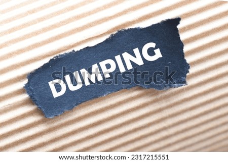 word DUMPING on torn paper, business concept