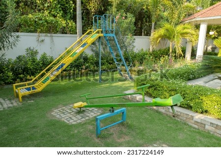 A small playground with seesaw and slide for children.