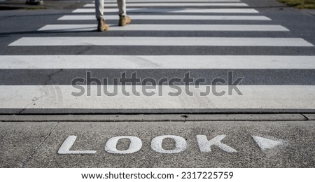 Pedestrian Crossing on the avenue in Sydney Australia, the warning word Look on street to keep pedestrian pay attention on the road before crossing Royalty-Free Stock Photo #2317225759
