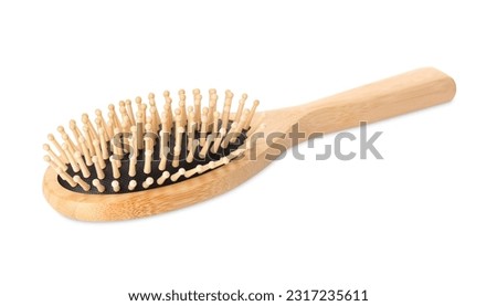 One new wooden hairbrush isolated on white Royalty-Free Stock Photo #2317235611
