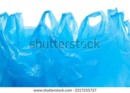 Many light blue plastic bags isolated on white