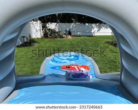 The perspective of looking down an inflatable water slide.