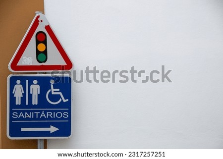 translation: toilets, wc

Traffic signs, various: direction indicators, prohibited turning, works, caution children... In a Portuguese city