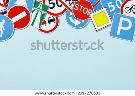 Driving school concept. Flat lay road signs and traffic symbols on color background.
