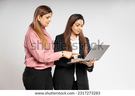Two indian businesswoman watching some detail in laptop.