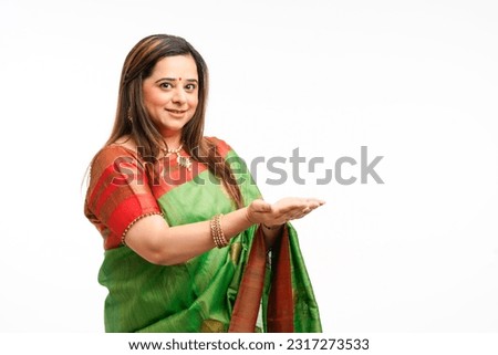 Indian woman in traditional sari and watching empty palm