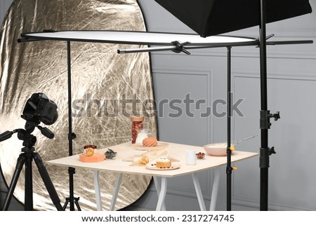 Professional equipment and composition with delicious desserts on table in studio. Food photography
