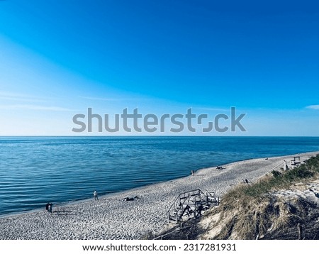 Blue sea and sandy coast, empty sandy beach, day time, blue seascape