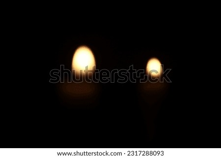 small candle in dark room with blurr image