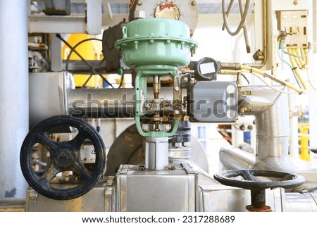 Pressure control valve in oil and gas process and controlled by Program Logic Control, PLC controller the valve and control instrument gas supply to actuator of the valve as PLC command. Royalty-Free Stock Photo #2317288689