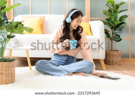 Young smiling woman happy watching movies and  chill relax in summer holiday. Lifestyle girl using laptop for entertainment in living room at home.  Lifestyle Concept 
