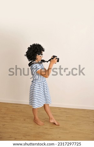 funny child holding photo camera