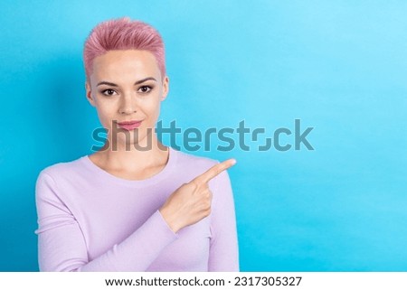 Photo of charming cute lady pink colored short hairstyle direct finger empty space novelty news isolated blue color background