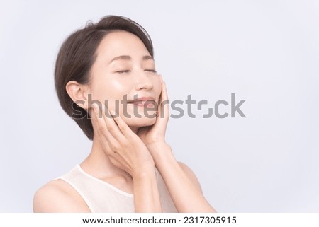 Skin care.Woman with beauty face touching healthy facial skin portrait.Asian woman. 