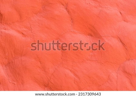 Red paint on the stone surface wall texture abstract background.