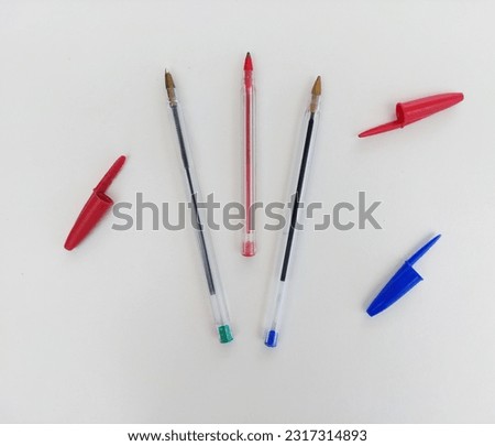 3 pens and 3 pens caps of diferent colors Royalty-Free Stock Photo #2317314893