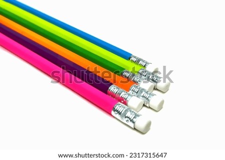 Pencils. Different colors and erasers. Lined up. Isolated. On a white background. Top view photograph