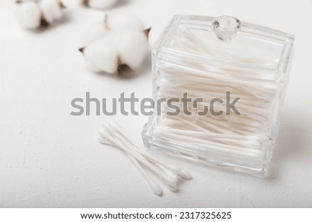 White cotton swabs on a concrete table background. Cotton buds. Hygienic cotton swabs for ears. Place for text. Place to copy.