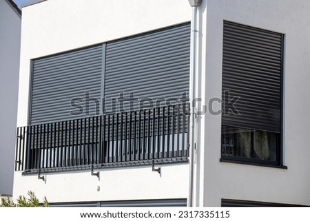 Electric aluminium roller shutter on a new residential building Royalty-Free Stock Photo #2317335115