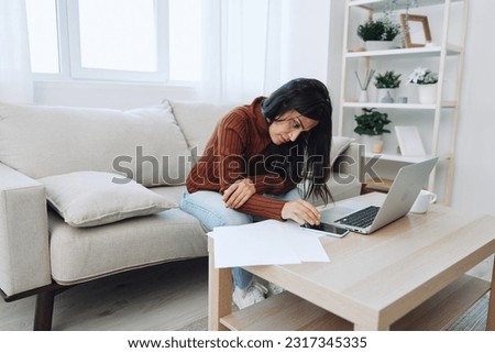 Sad freelance woman typing on laptop and working online from home