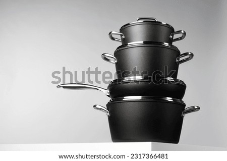 New domestic cookware on grey background close up Royalty-Free Stock Photo #2317366481