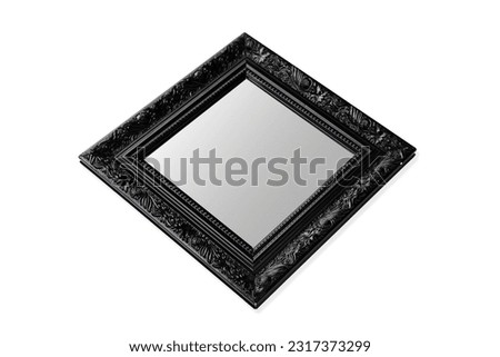 Square mirror reflection with ornate black frame, isolated over white background. Classic style, layout decoration. Social media format. Interior design, oblique view. Frame border blank inside.