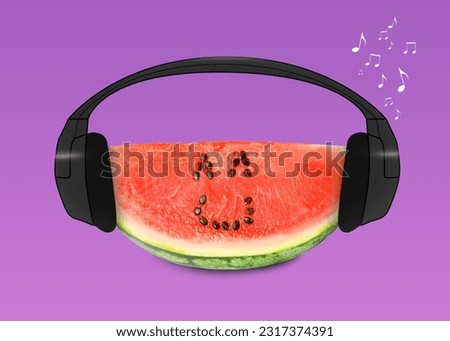Creative artwork. Watermelon listening to music in headphones on magenta background. Slice of fruit with drawings, eyes and smile made of watermelon seeds