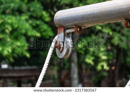 The pulley and rope are fixed to the steel frame. Royalty-Free Stock Photo #2317383567
