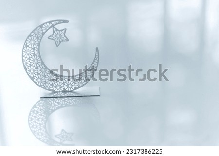 Eid Mubarak concept background, Crescent moon shape isolated on white background, Minimal type Ramadan greeting image with copy space Royalty-Free Stock Photo #2317386225
