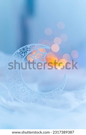 Crescent moon shape isolated on bokeh lights, Islamic new year concept background for Eid and Ramadan Mubarak  Royalty-Free Stock Photo #2317389387