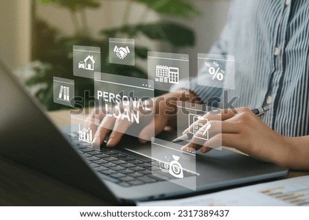Women use a computer with the personal loan icons on a virtual screen of the future and see the inscription. Personal loan. Business, Technology, Personal expenses concept. Financial analysis. Royalty-Free Stock Photo #2317389437
